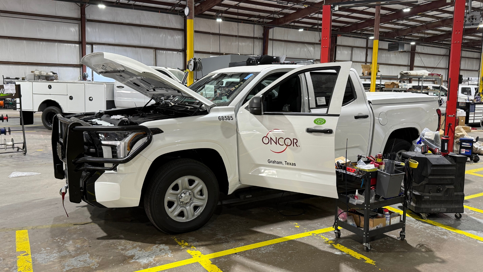 An Oncor Toyota Tundra undergoing fleet outfitting inside a Texas workshop