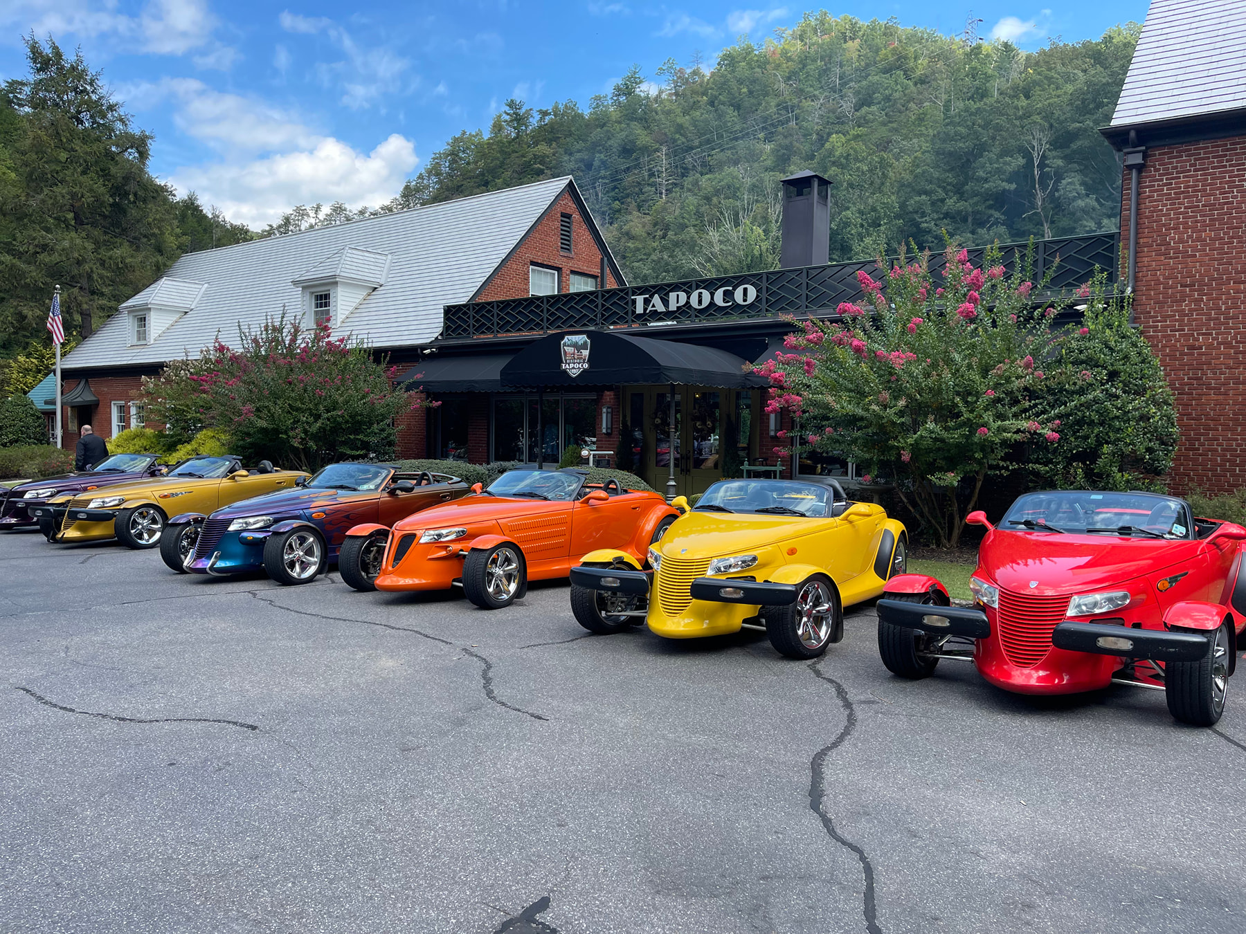 Colorful classic cars lined up in front of Historic Tapoco Lodge
