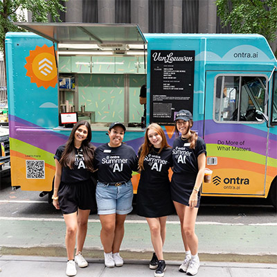 Four Ontra team members standing beside a brightly painted company ice cream truck