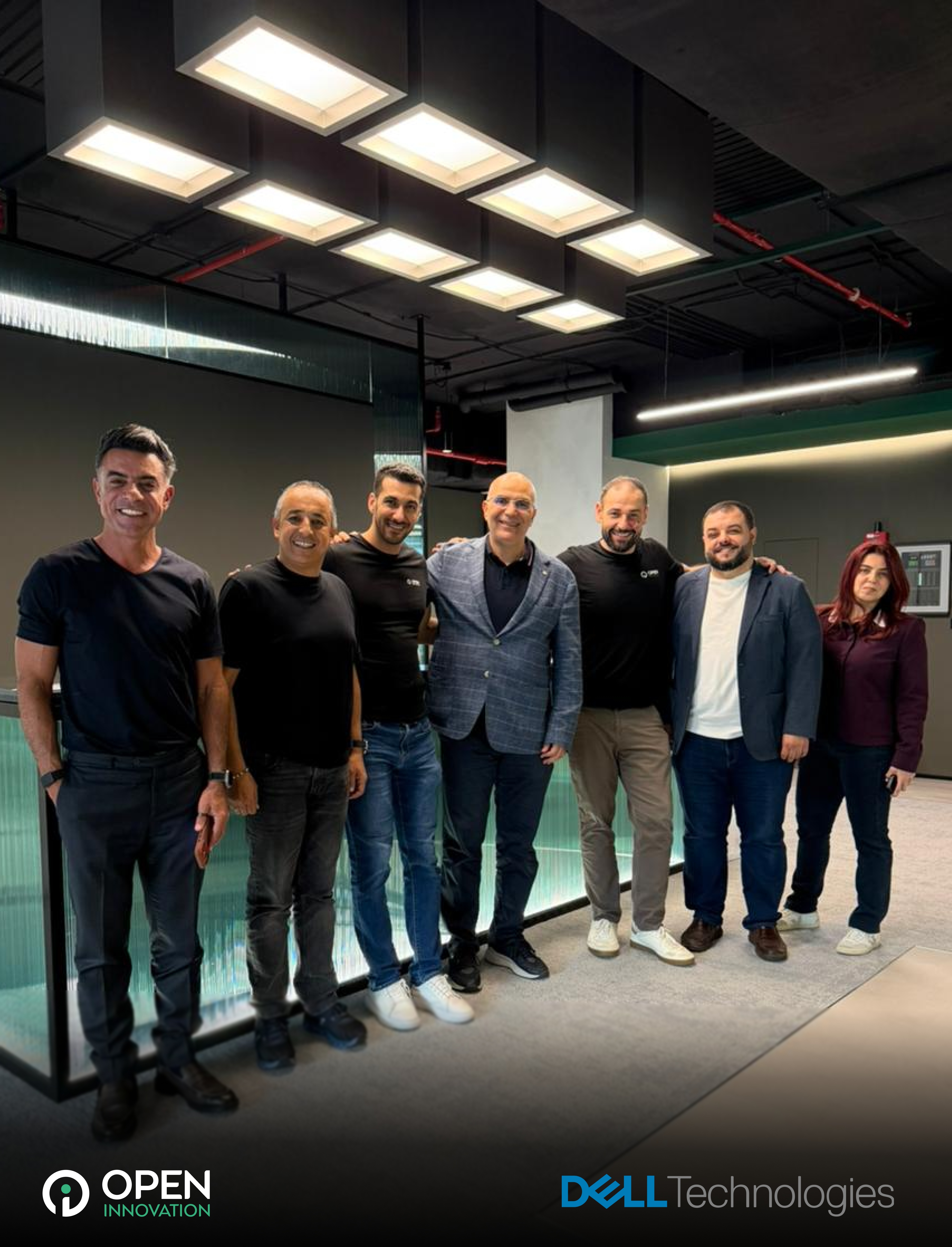 Open Innovation AI and Dell Technologies team members standing together during a collaboration meeting