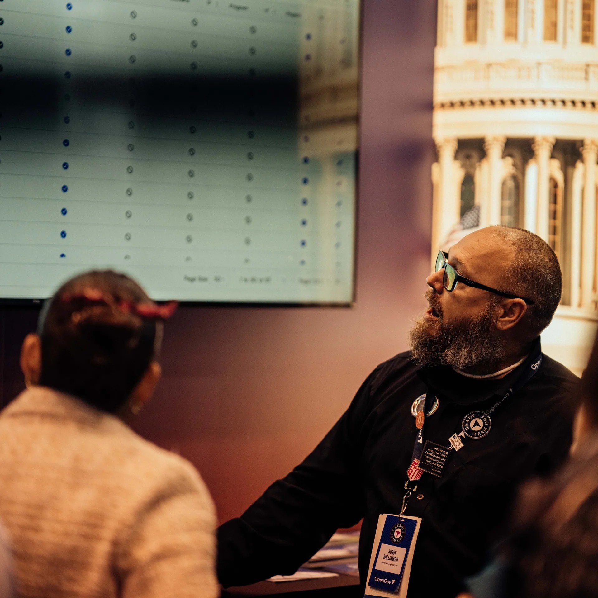 An OpenGov event attendee studying a workflow display