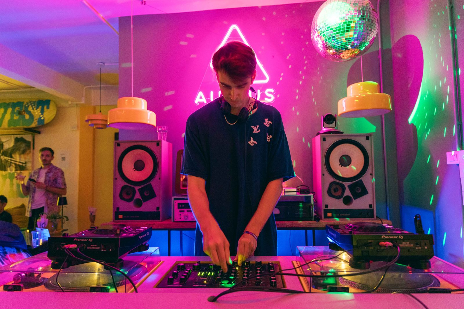 A live OpenHome demo event with a person performing at the decks under OpenHome branding