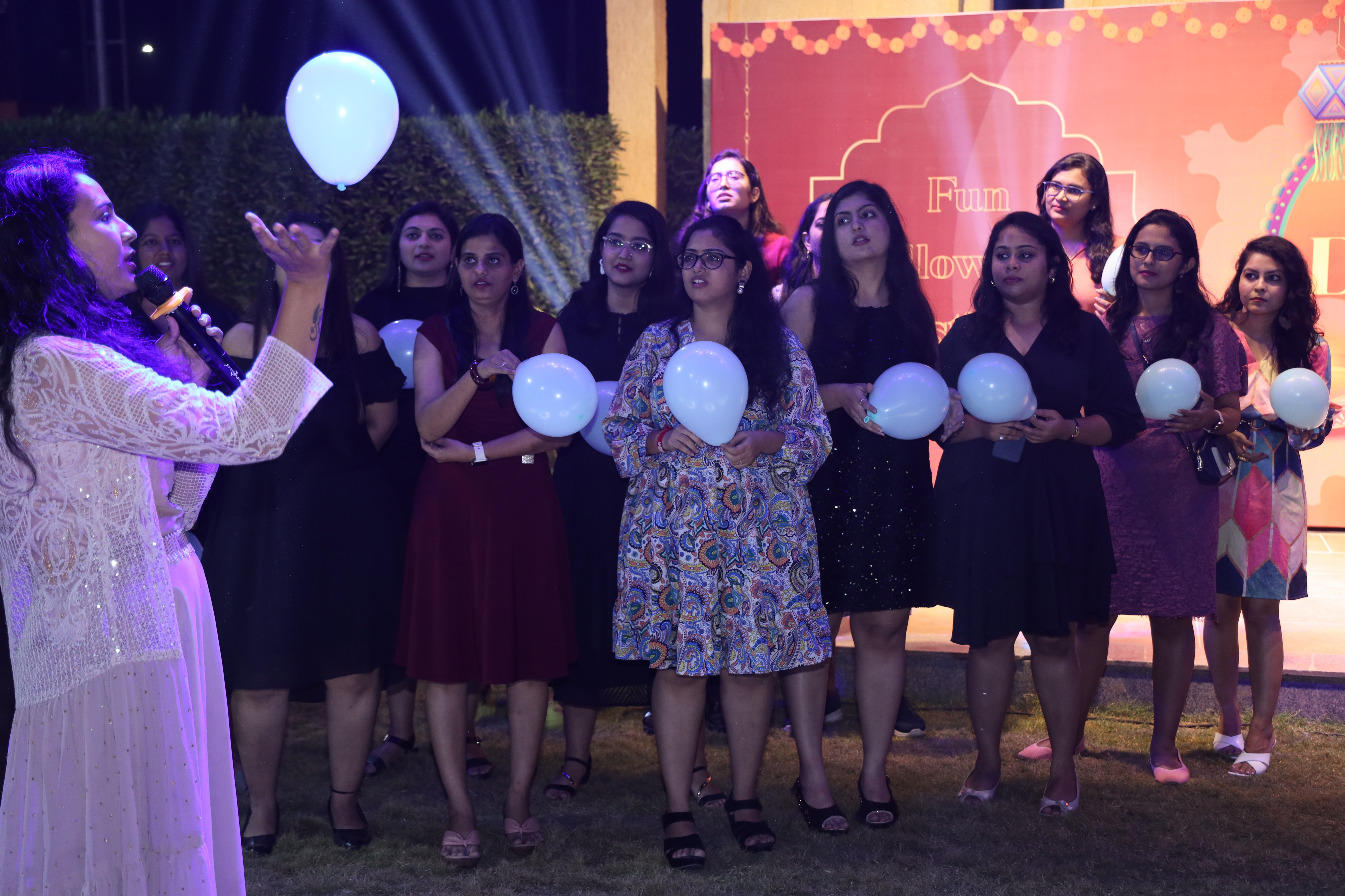 Openxcell team members participating in a balloon game at a company event