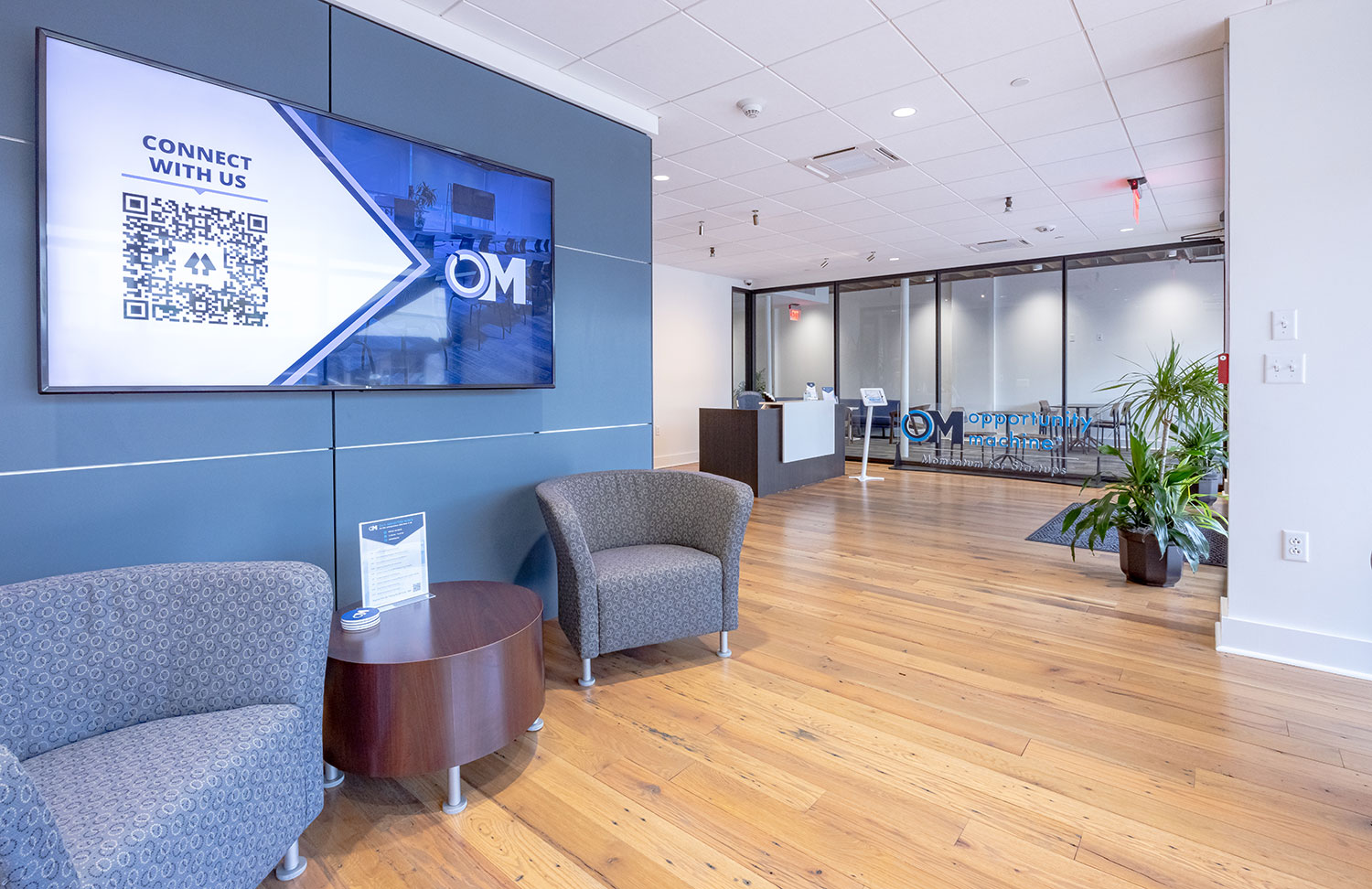Seating and glass-fronted workrooms inside Opportunity Machine’s Lafayette office