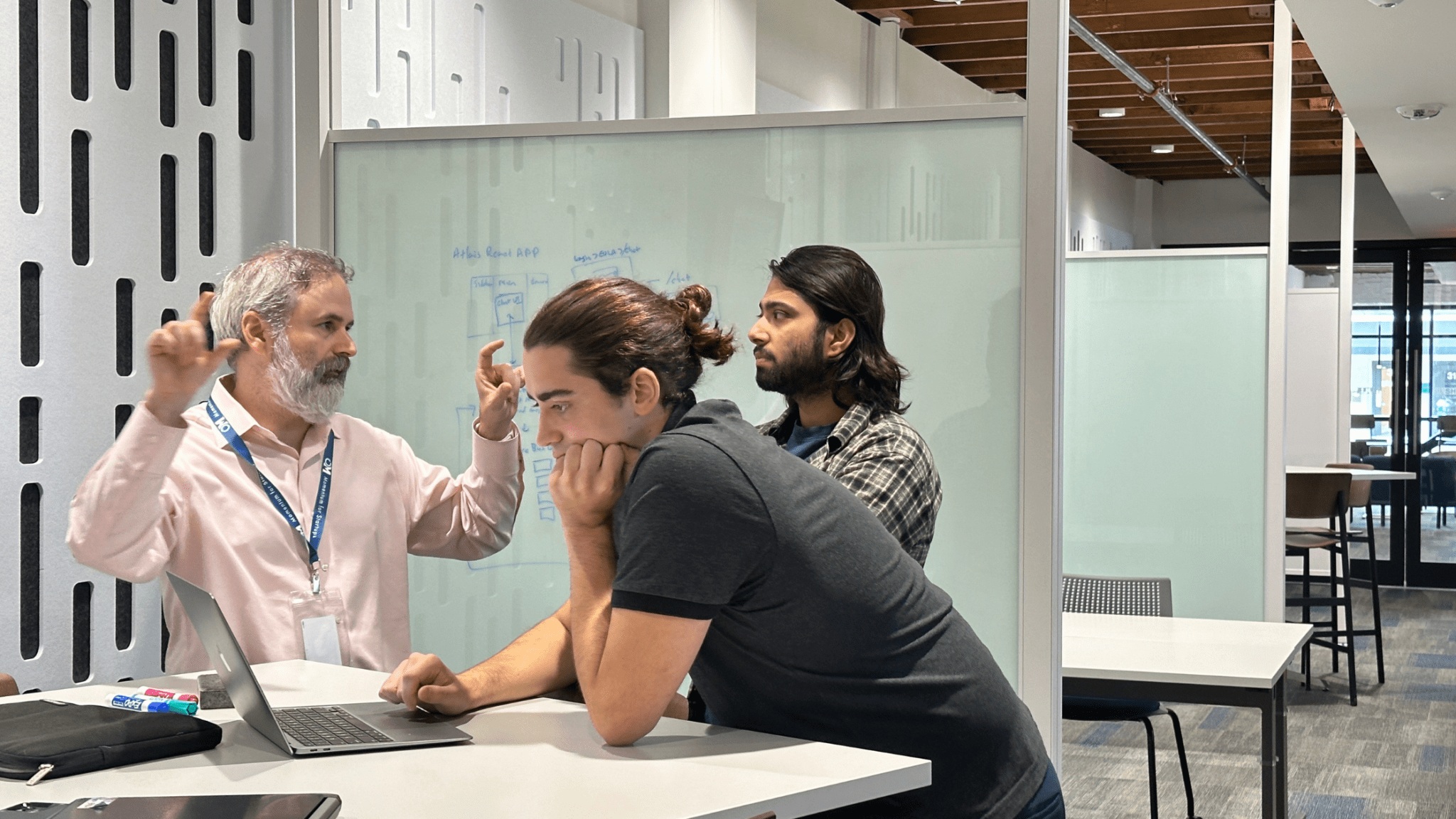 Atlais founder Ryan Bourque discussing development work with interns Andrew Stelly and Subigya Gautam