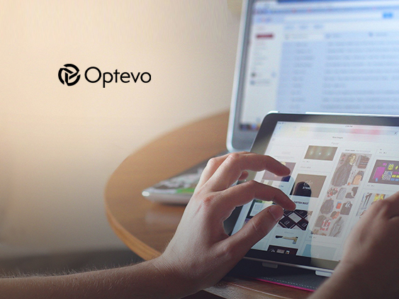 A person using a tablet beside a laptop, with an Optevo wordmark on the wall