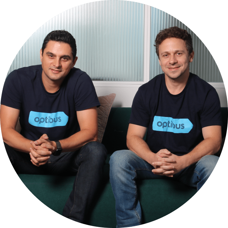 Optibus co-founders in branded shirts, seated together