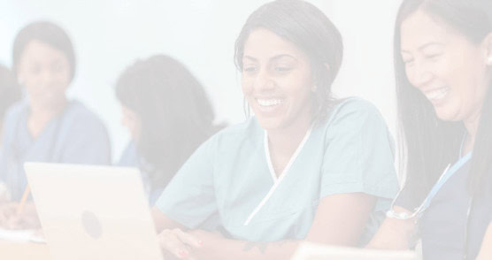 Two healthcare workers reviewing a laptop in a company-published illustrative photograph