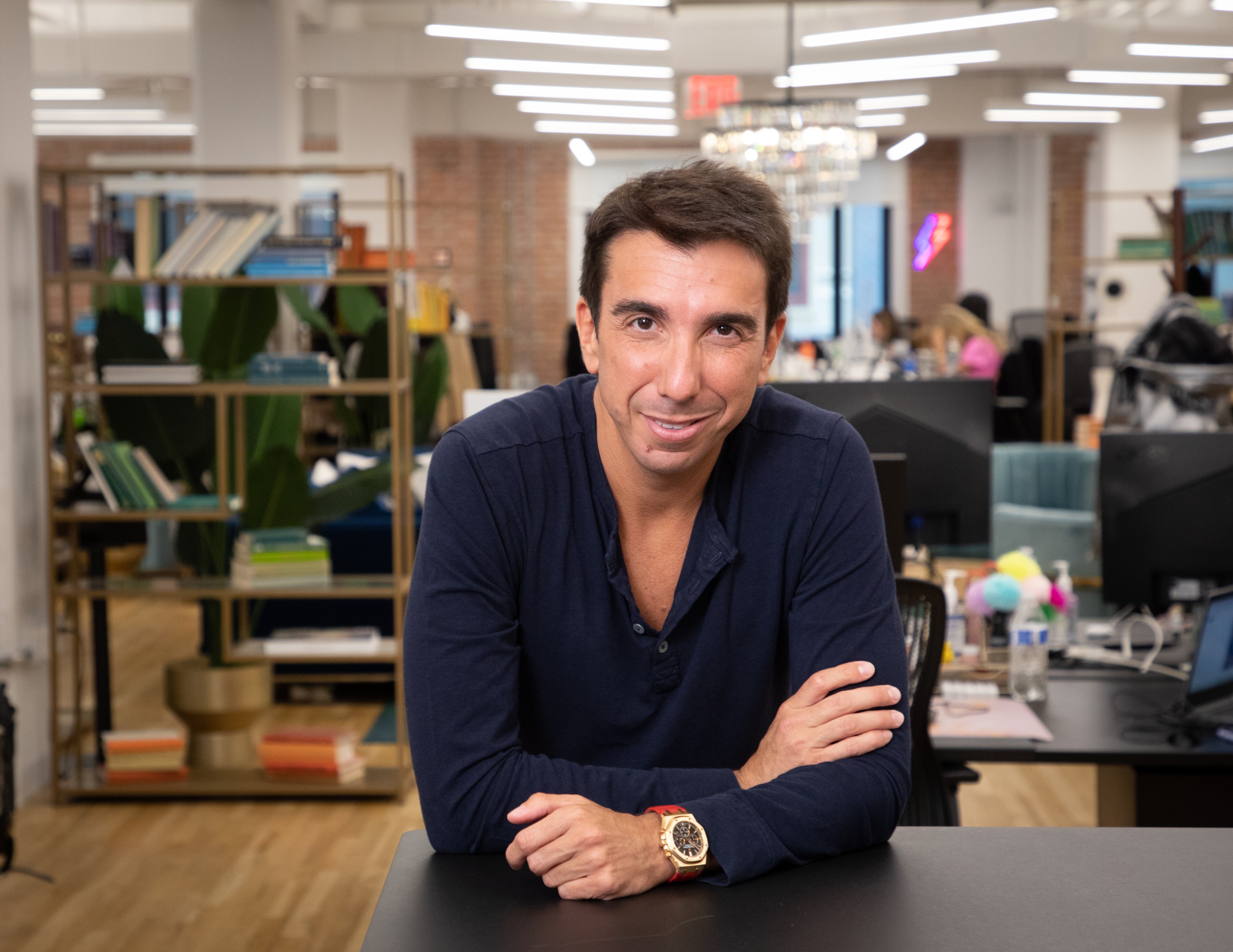Oran Holtzman seated at a desk in an open-plan office