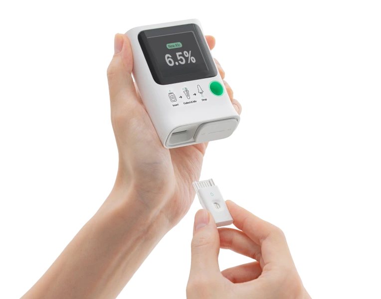 Orange Biomed A1C meter, cartridge and blood collection accessories on a white background