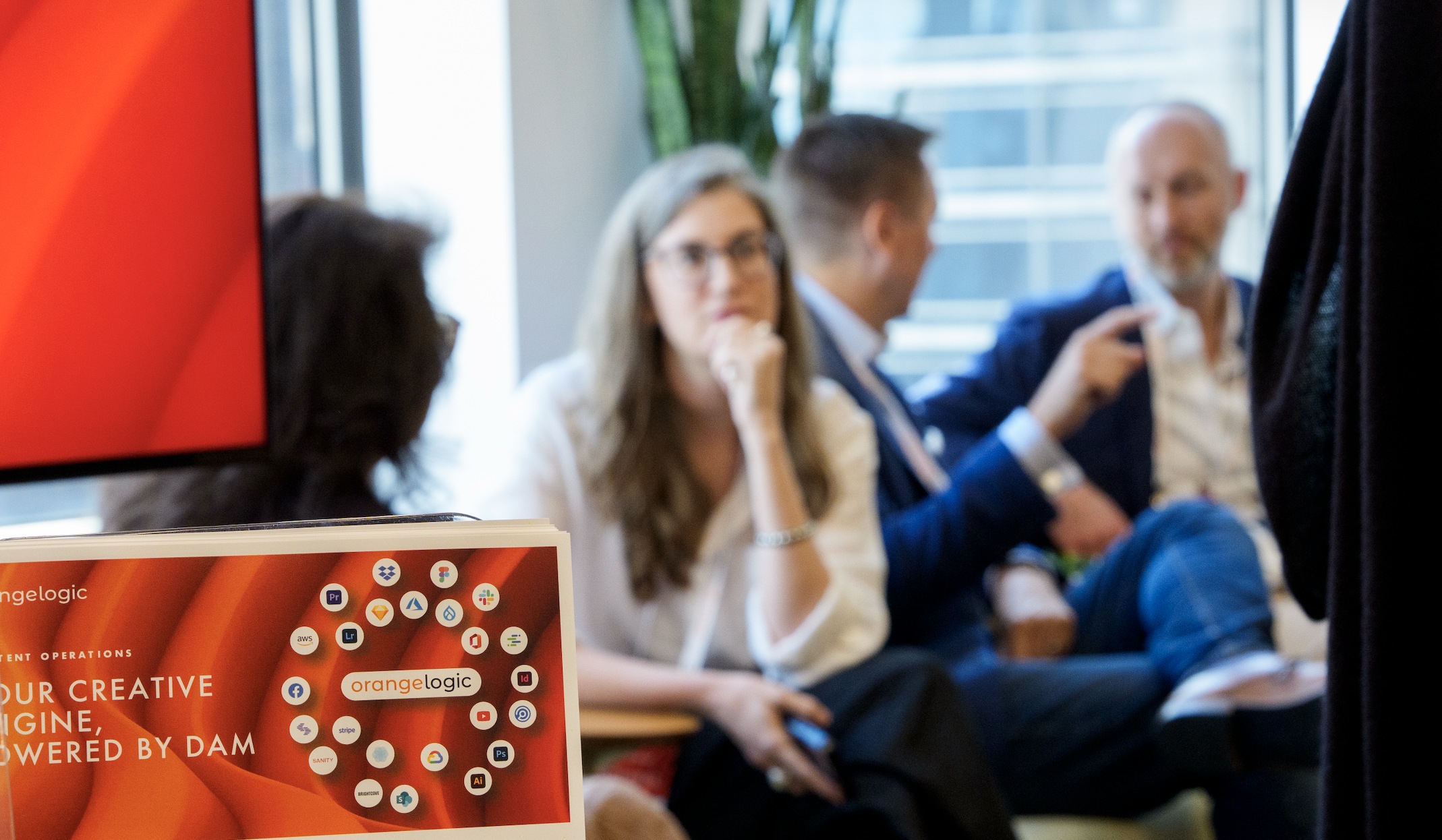 A discussion pictured on Orange Logic’s company website, with branded integration materials in the foreground