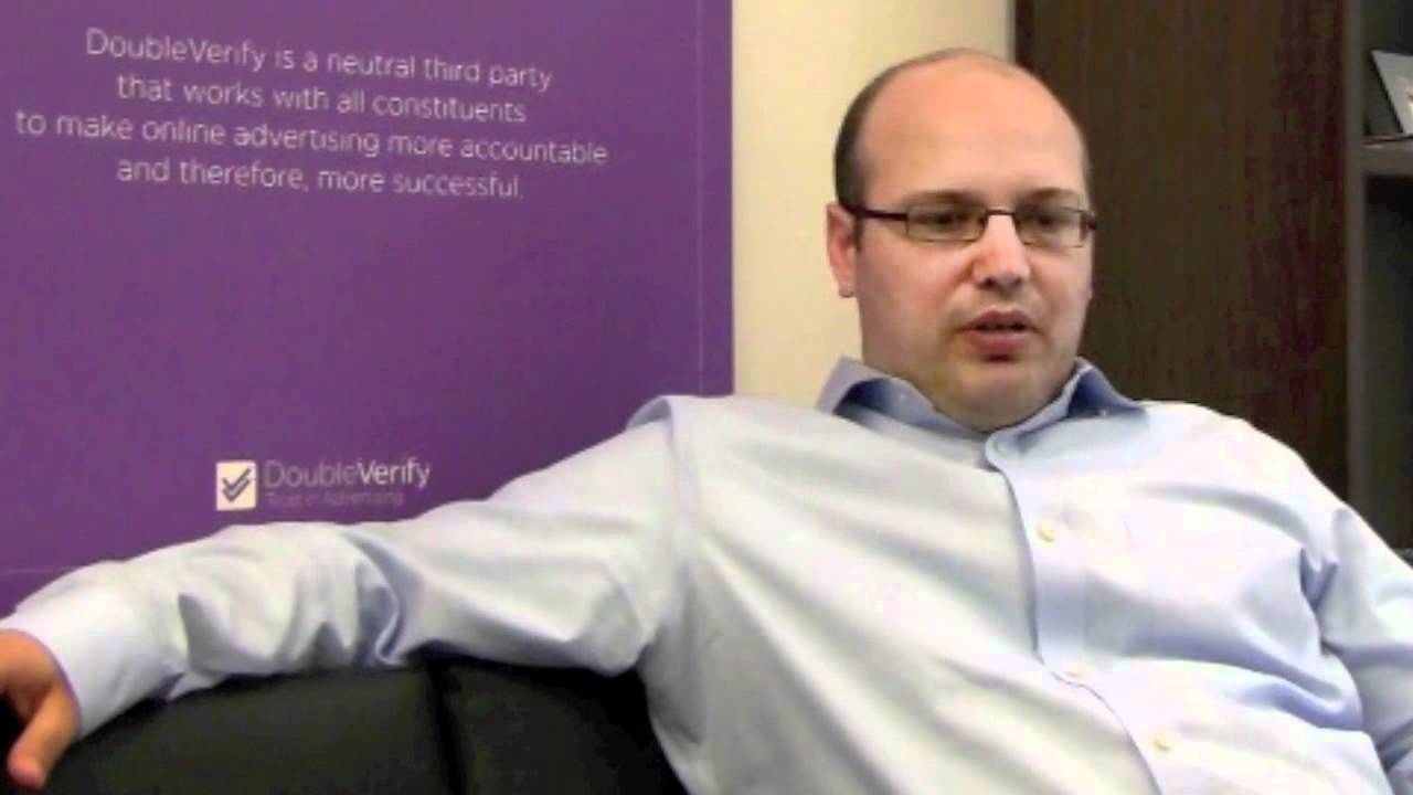 Oren Netzer seated beside a DoubleVerify banner during a World Economic Forum interview