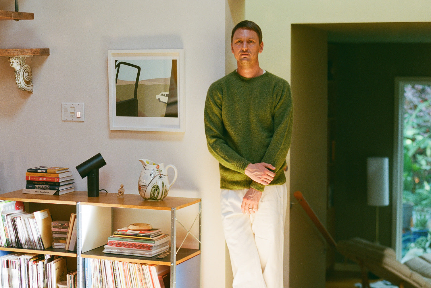 Orienteer co-founder Nick Dierl standing beside shelves of records and books