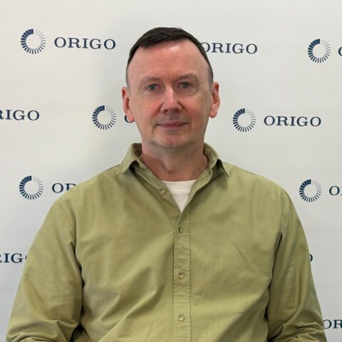 Origo chief executive Anthony Rafferty in front of an Origo backdrop
