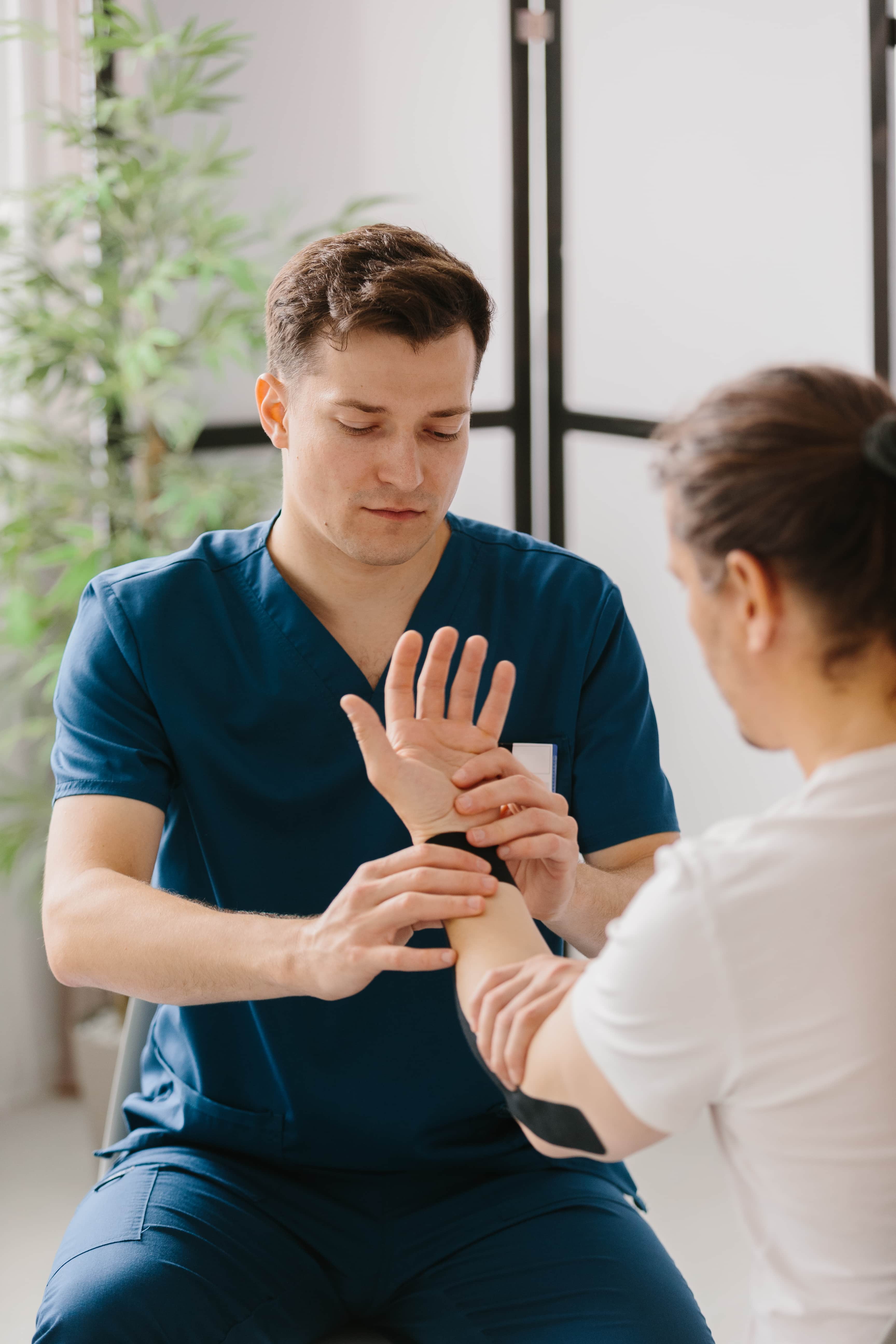 A clinician examining a patient's wrist