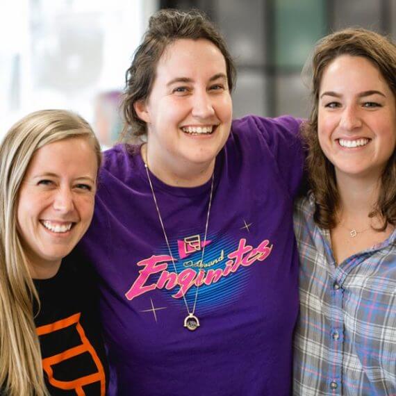Three smiling OutboundEngine team members in a photograph published on the company about page