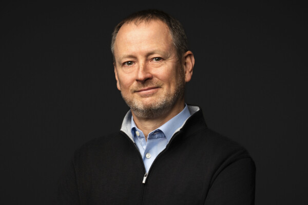 OutSystems chief executive Woodson Martin against a dark studio background