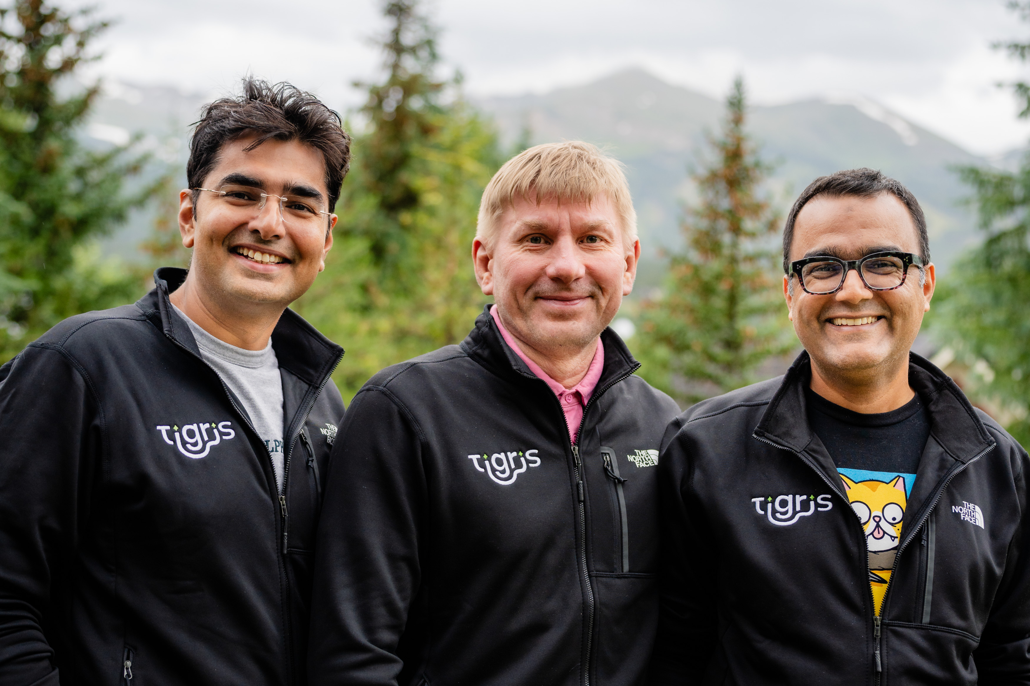 The three Tigris co-founders outdoors, wearing Tigris jackets