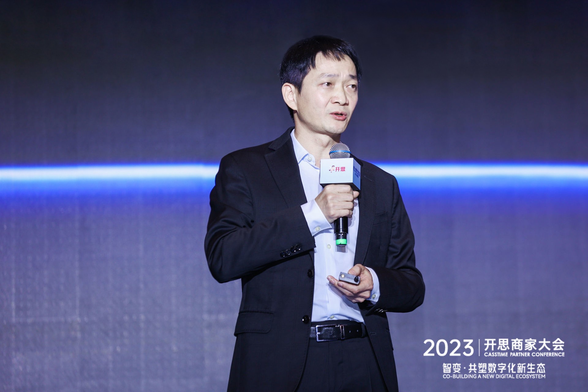 Overmars Jiang speaking with a microphone at the 2023 CassTime Partner Conference