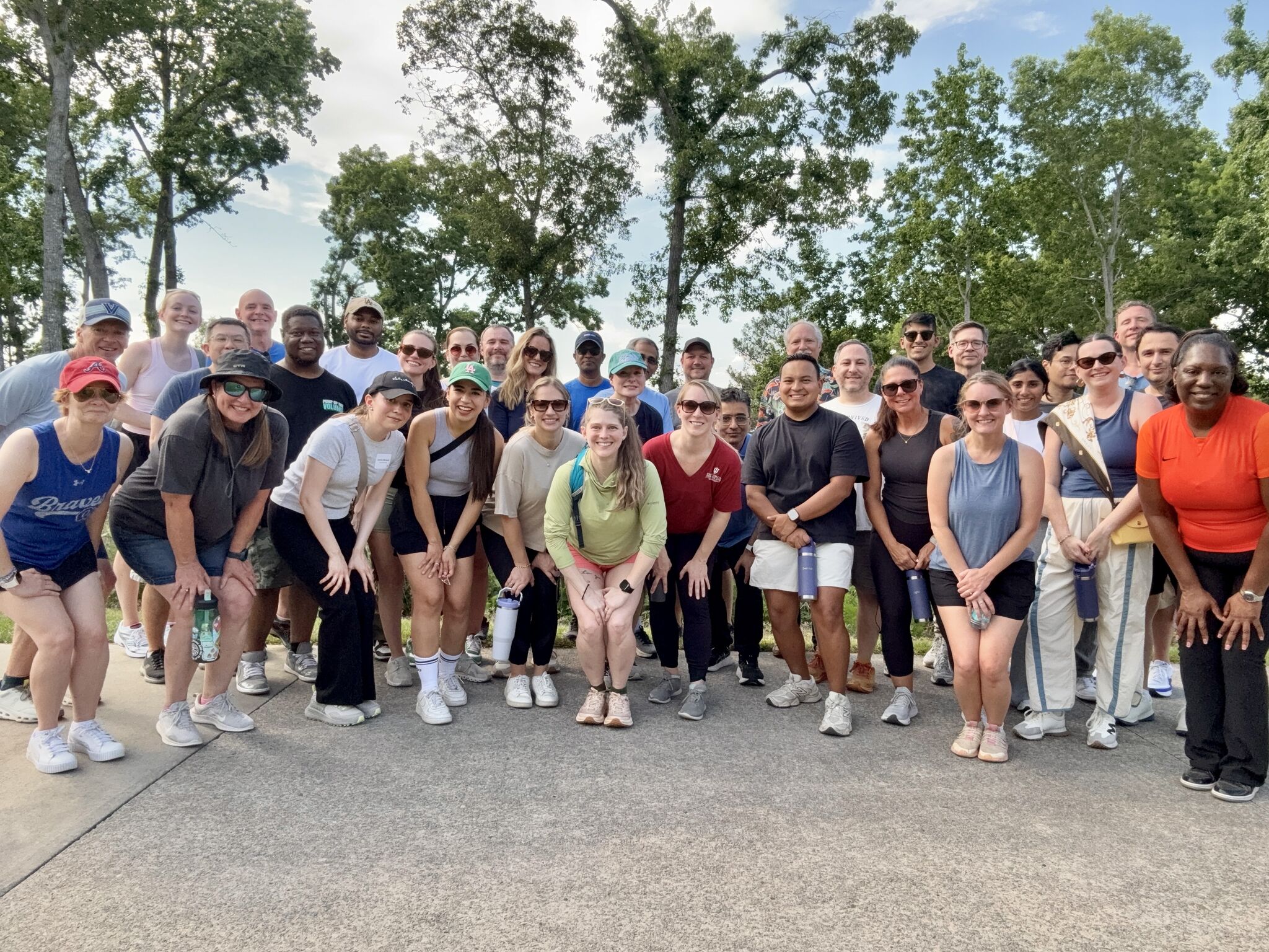 Oversight employees gathered outdoors for a company team photograph