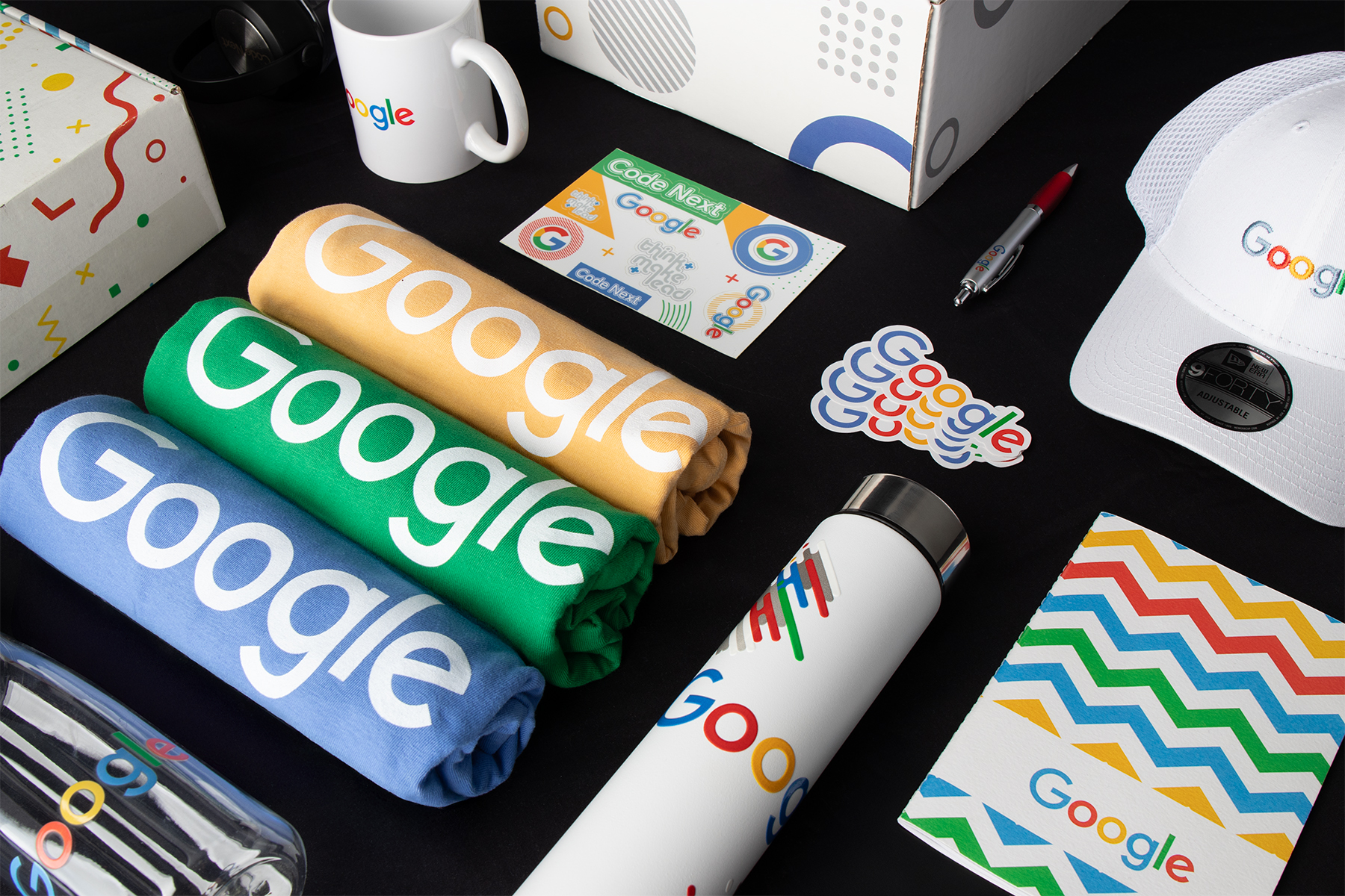 Google-branded shirts, drinkware, cap, stickers, and packaging displayed in Overture’s merchandise photography