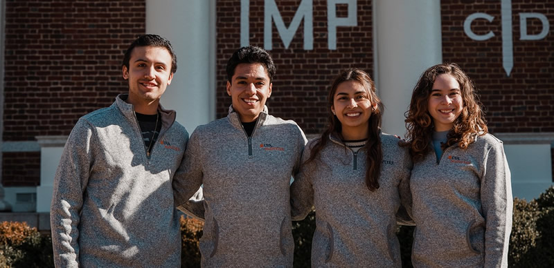 Pablo Calvo Boullosa and three fellow members of the Latinx Student Network outside UVA McIntire School of Commerce