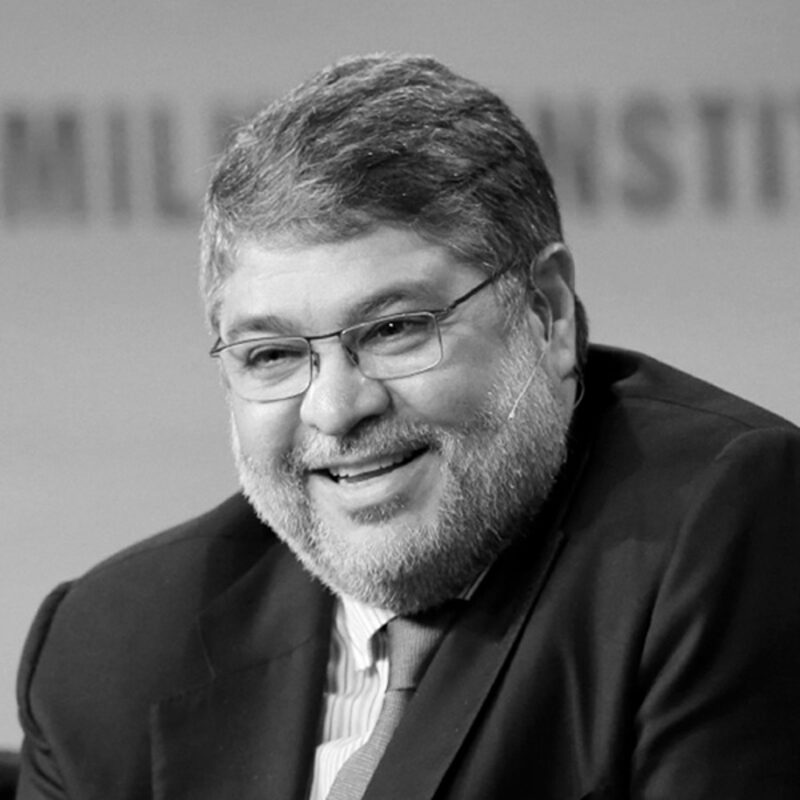 Pablo Legorreta smiling during a public speaking appearance, wearing a headset microphone