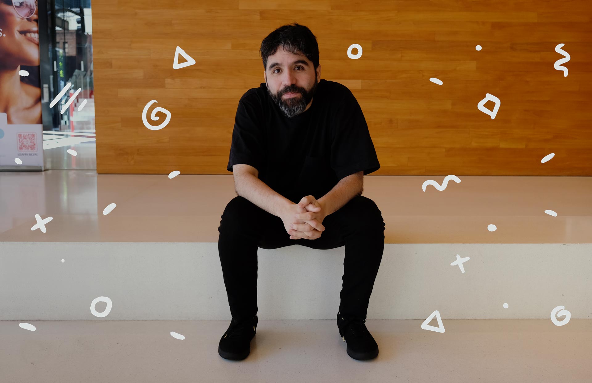 Pablo Stanley seated at a wooden wall in a photograph published with his 2024 Config interview