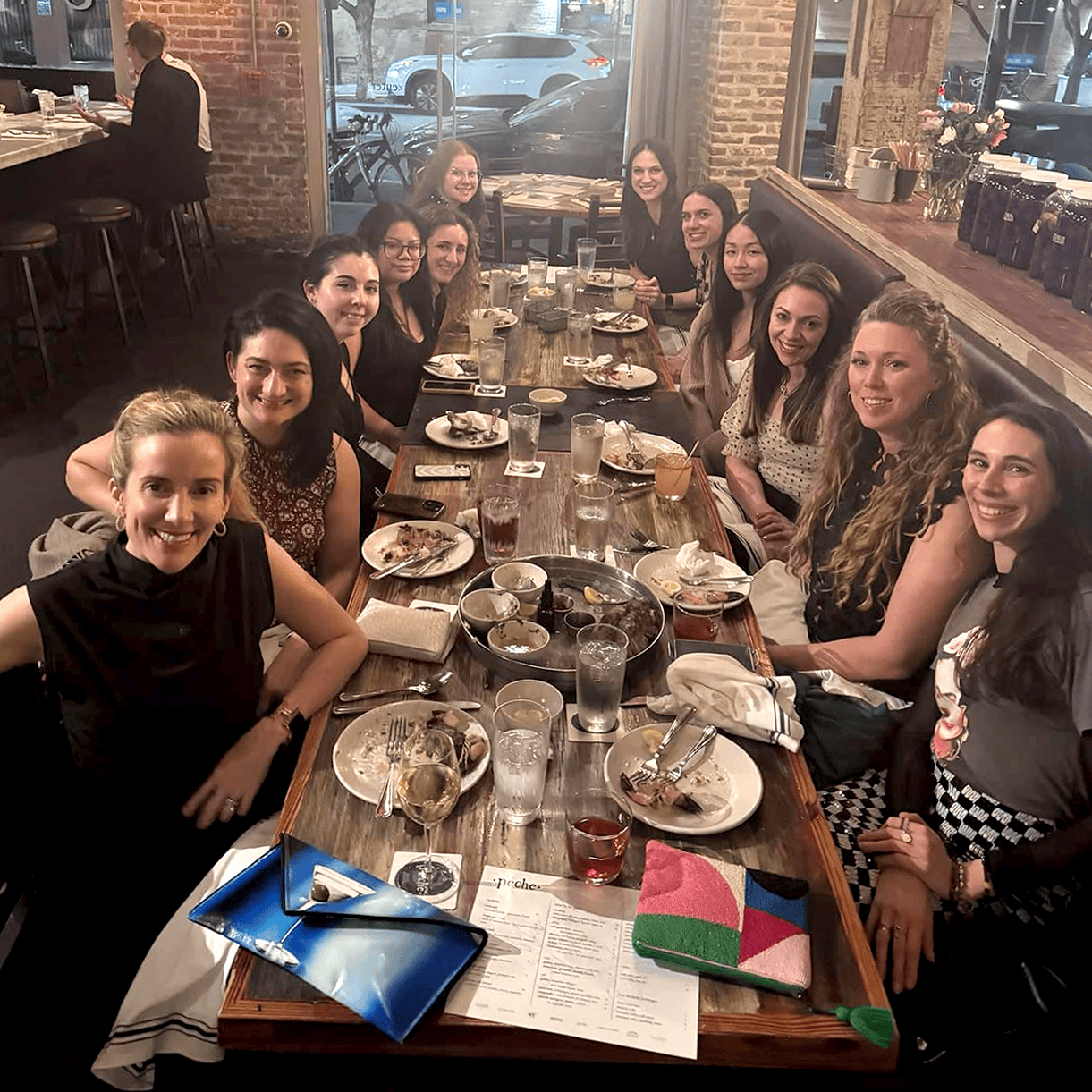 Members of the Pace Public Relations team gathered around a restaurant table
