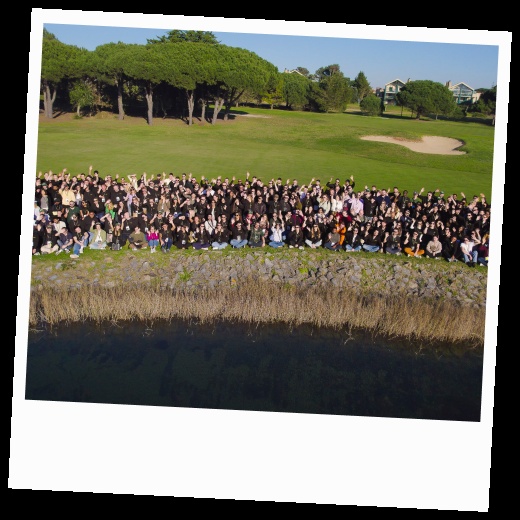 Paddle employees gathered outdoors in a large group, in a framed photograph from its careers page