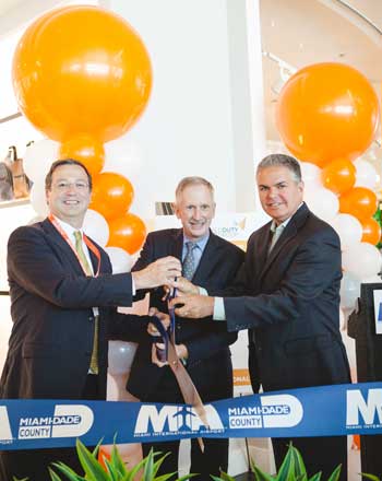Padraig Drennan, left, at a Miami airport ribbon-cutting with Ken Pyatt and Bruno A. Barreiro in 2015