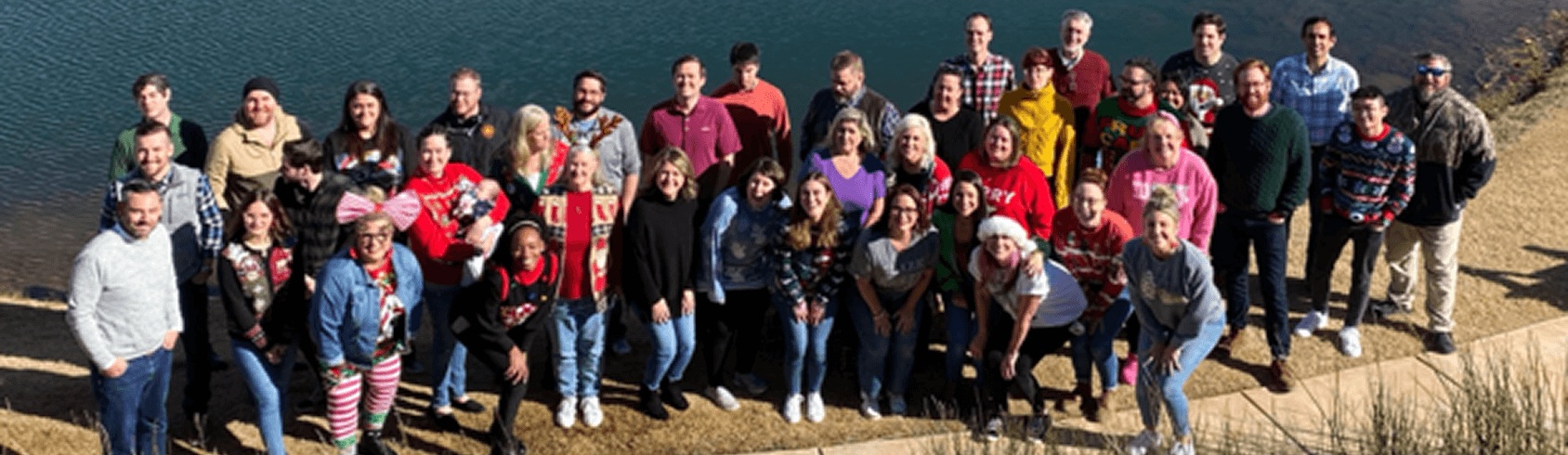 A group pictured beside water in PakEnergy’s company team gallery