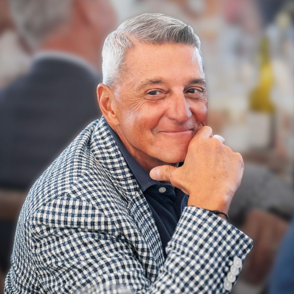 PAN founder Phil Nardone in a checked jacket, resting his chin on his hand