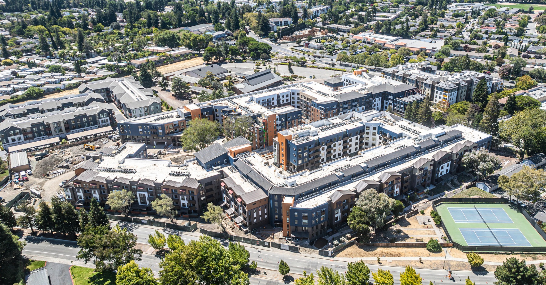 Aerial view of a large residential development with multiple buildings and surrounding streets