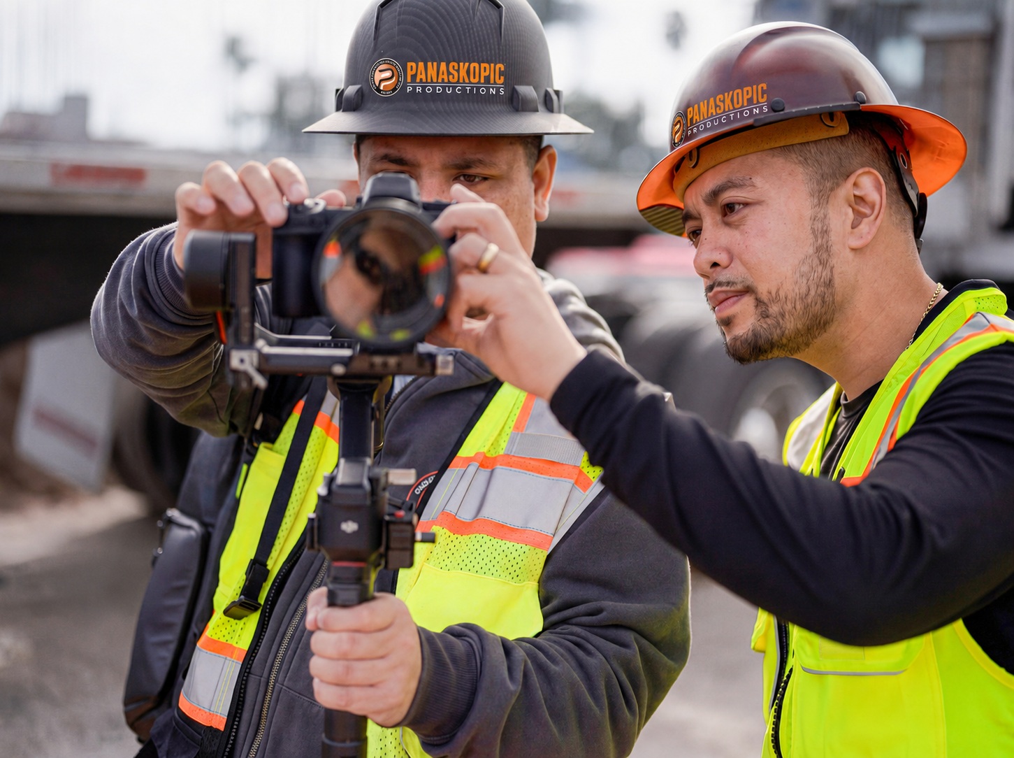 Two Panaskopic field team members in hard hats operating a camera stabilizer