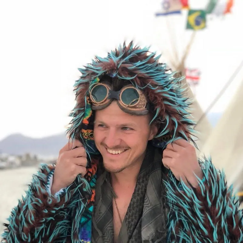 PandaDoc co-founder Mikita Mikado wearing a furry coat and goggles at Burning Man