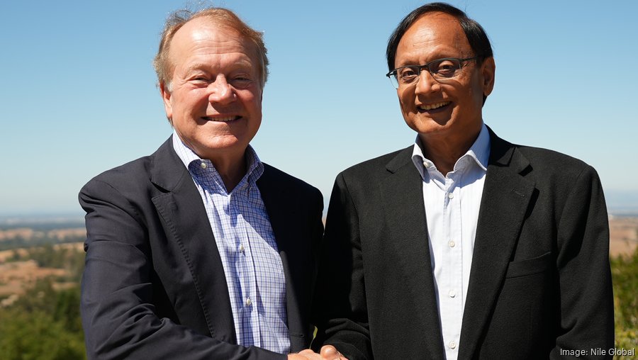 John Chambers, left, and Pankaj Patel smiling together outdoors