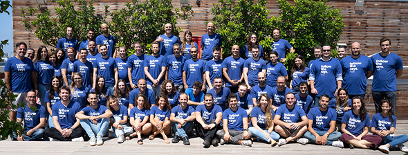 The Panorays team gathered outdoors in matching blue shirts