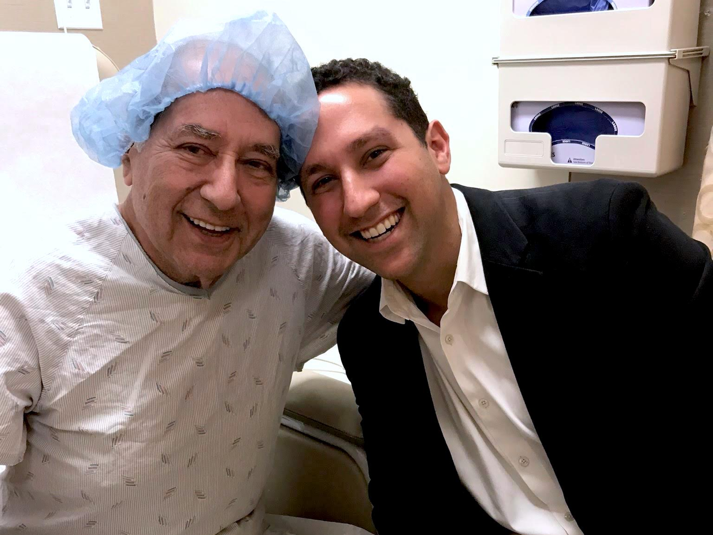 David Gelbard, right, with his father in a medical examination room