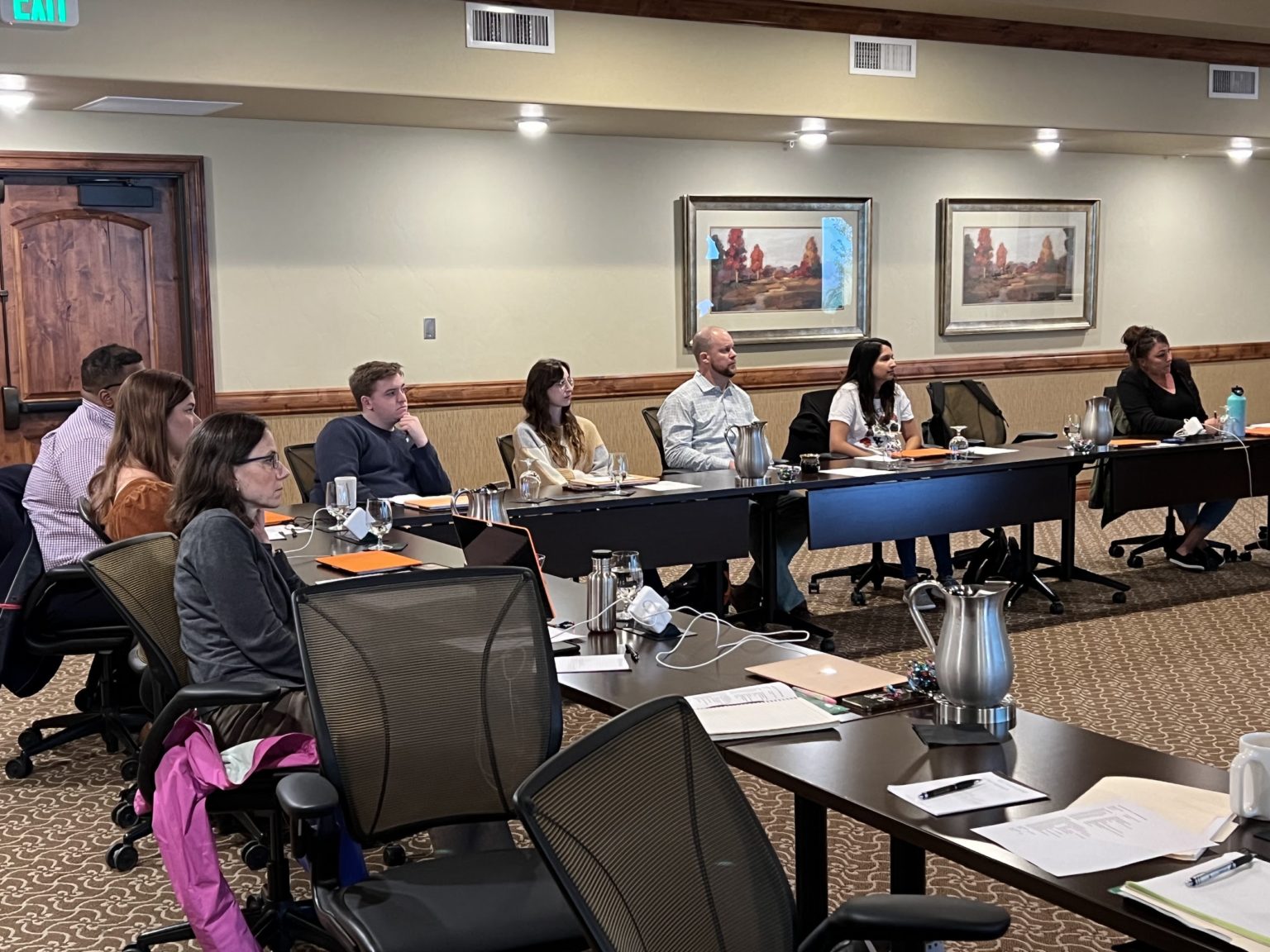 Paragon PR colleagues seated around a conference room table during the company's Colorado Springs offsite