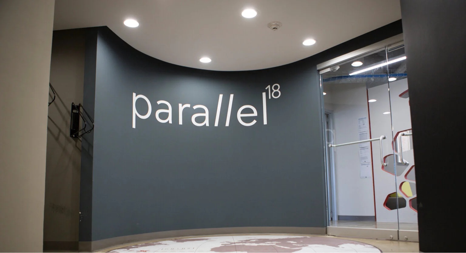 An archival photograph of the Parallel18 office entrance, with its name on the wall