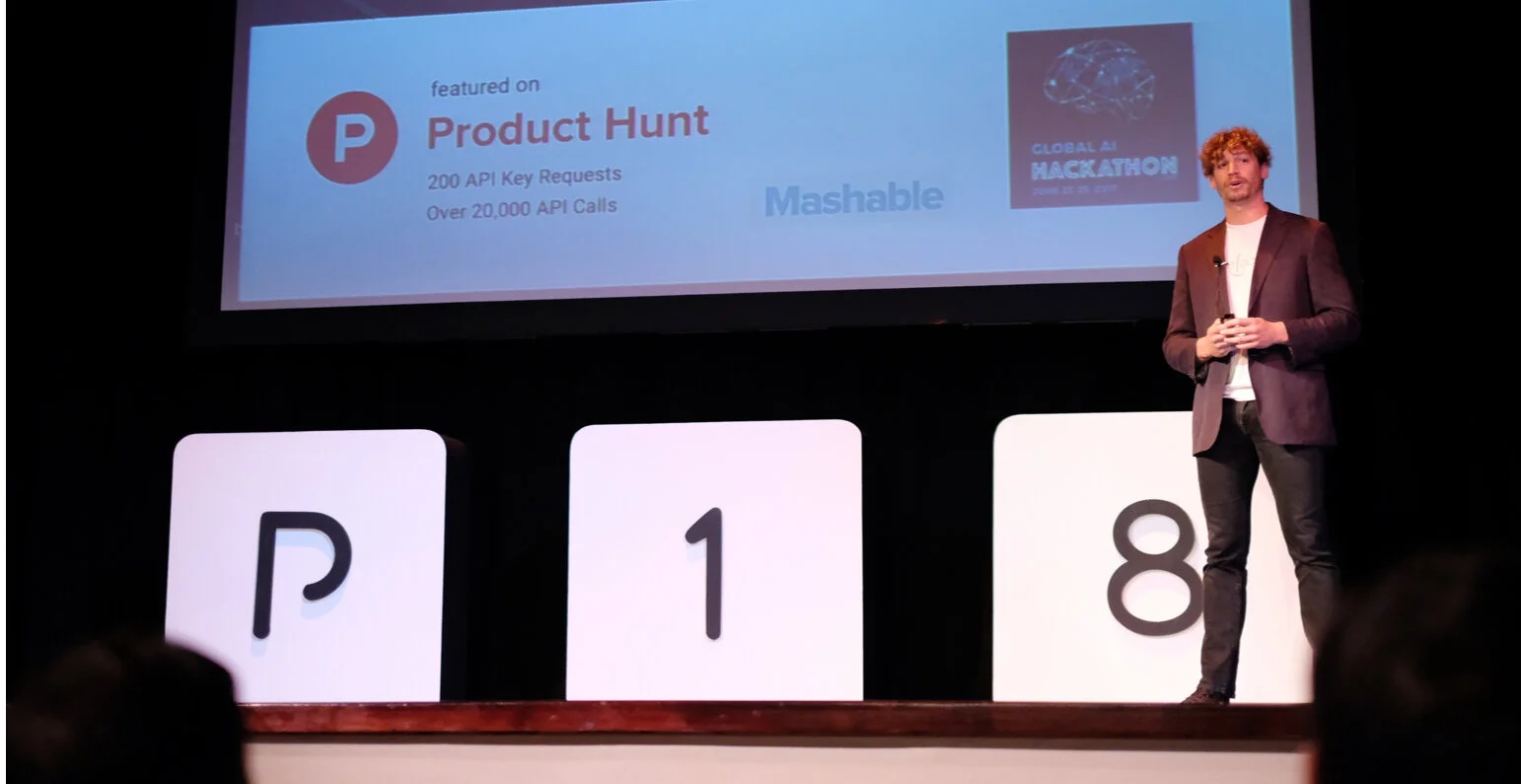 A founder presenting business results on stage at an archival Parallel18 Demo Day