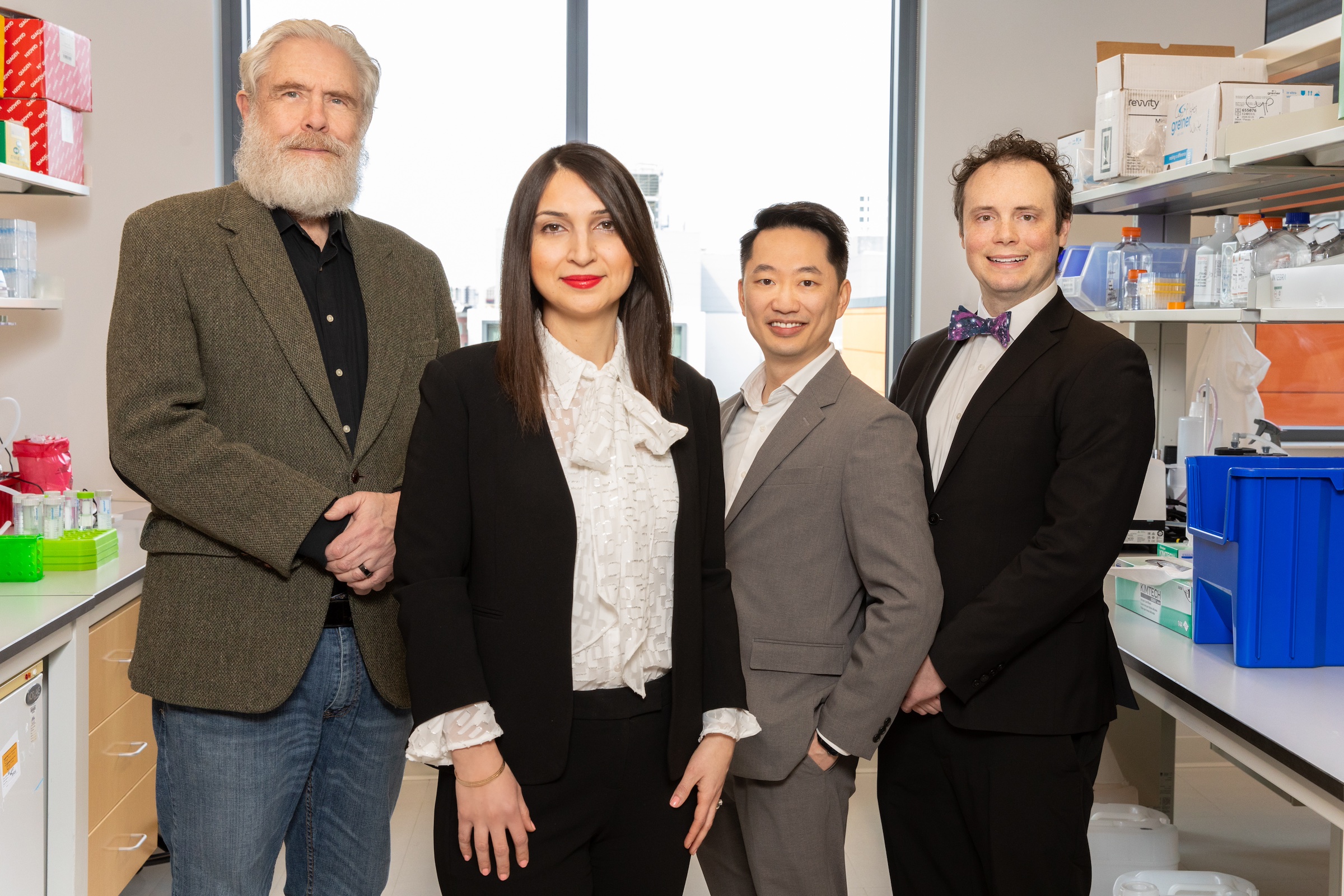 George Church, Parastoo Khoshakhlagh, Alex Ng, and Cory Smith standing together in a laboratory