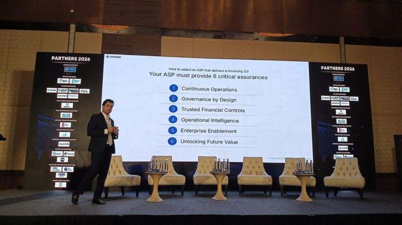 Paresh Bafna speaking beside a slide listing six assurances for an enterprise e-invoicing provider at GATE Summit Abu Dhabi 2026.