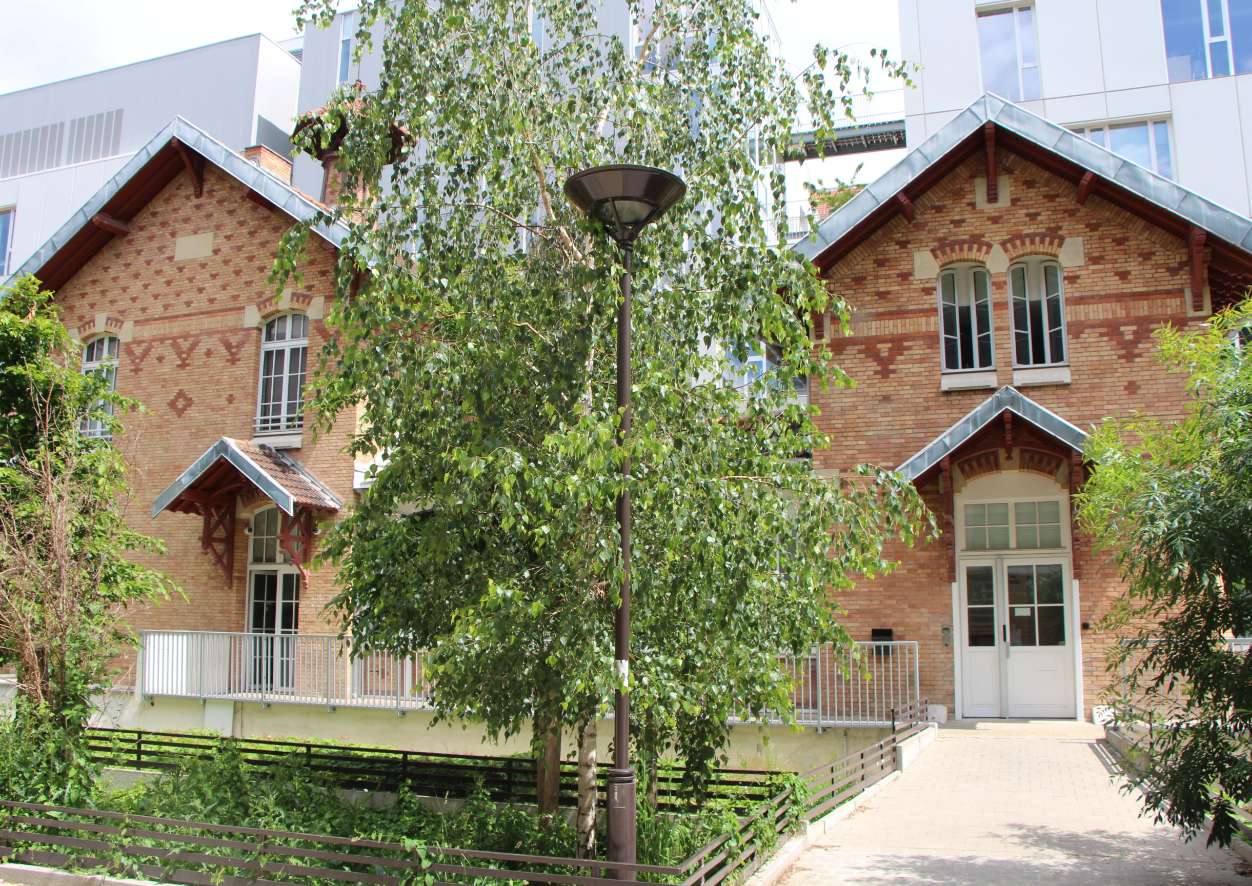 A brick building and courtyard pictured in Paris&Co’s locations section
