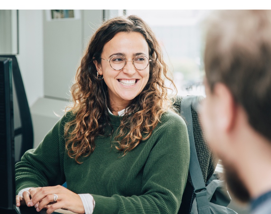A photograph from Paris&Co’s team section showing two people in conversation
