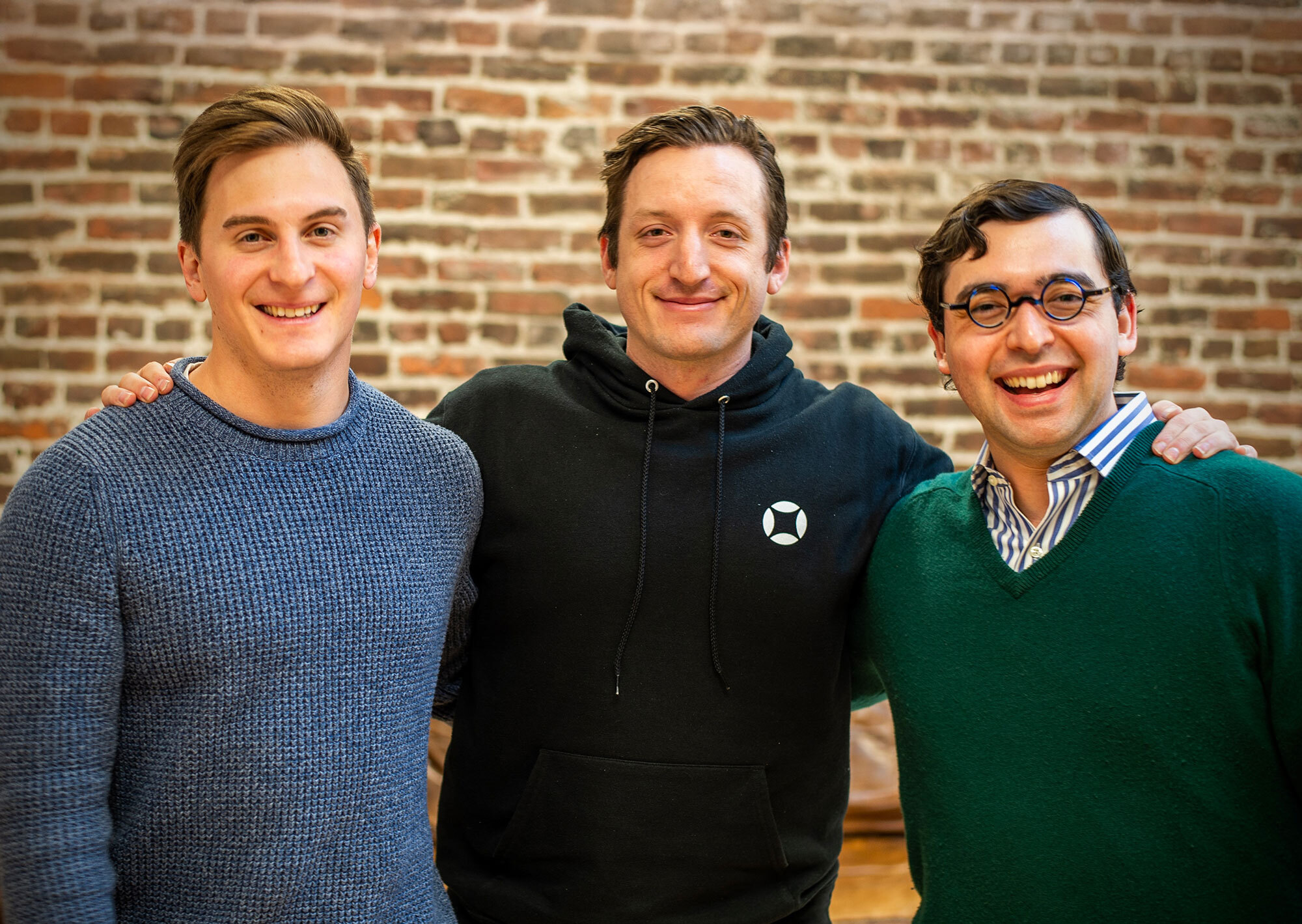 Numeric co-founders Andrew Bihl, Parker Gilbert, and Anthony Alvernaz standing together in an office