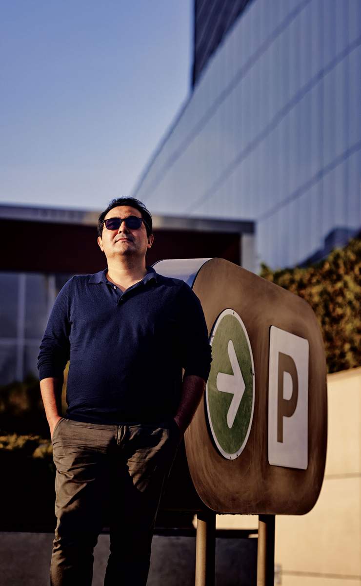 Parqour founder Amirkhan Omarov beside a parking sign