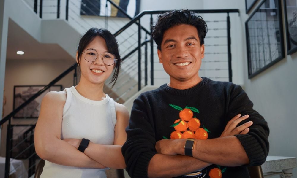 A1Base co-founders Pennie Li and Pasha Rayan standing together indoors
