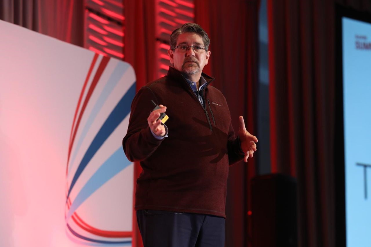 Patrick Donovan speaking on stage at Axway Summit 2024 in Denver